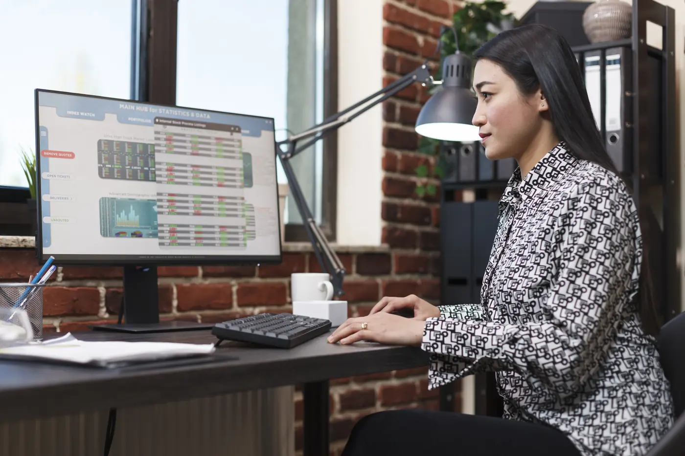 A learner at a desk reviewing market data on a computer screen